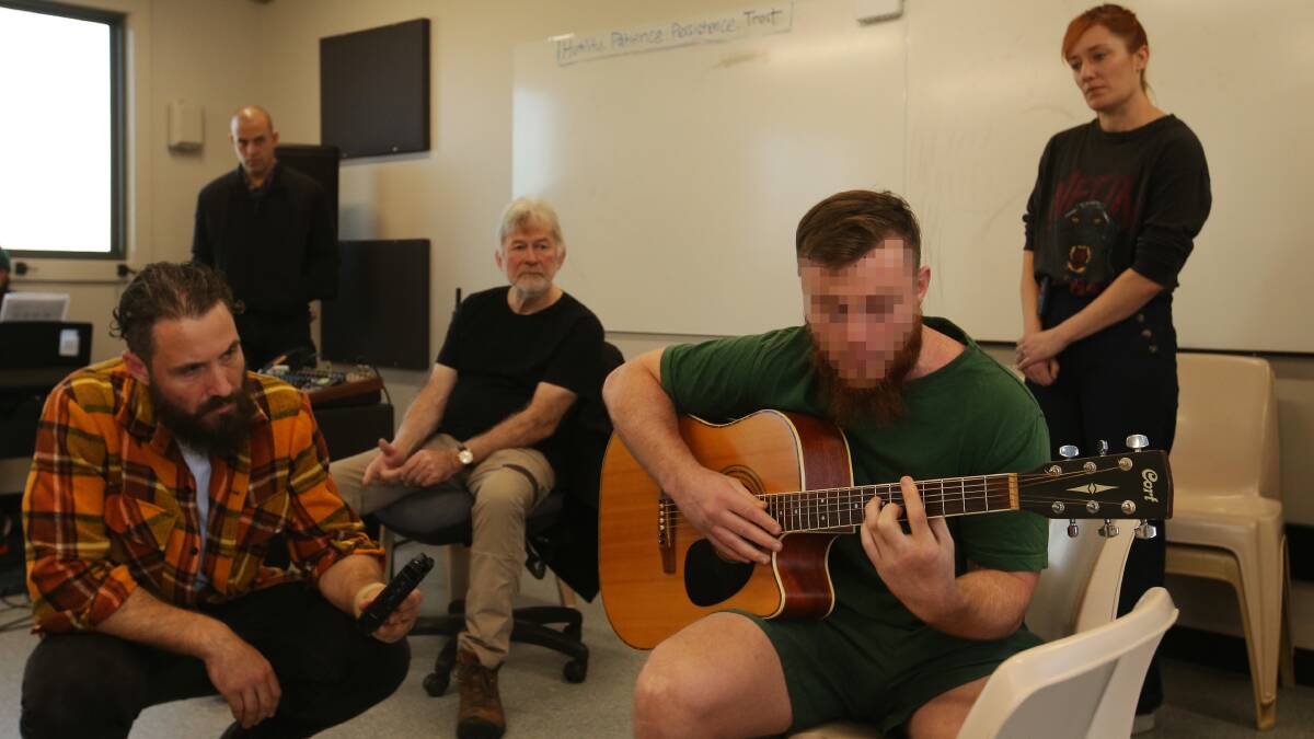 William Crighton, Ben Leece, John Schumann and Julieanne Crightonr rehearsing with an inmate at Hunter Correctional Centre earlier this year. Picture by Simone De Peak