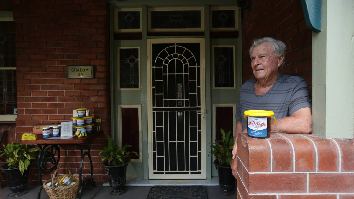 COME AND GET IT: Beekeper Neil Livingstone sells his honey from the verandah of his Mayfield home. Picture: Simone De Peak