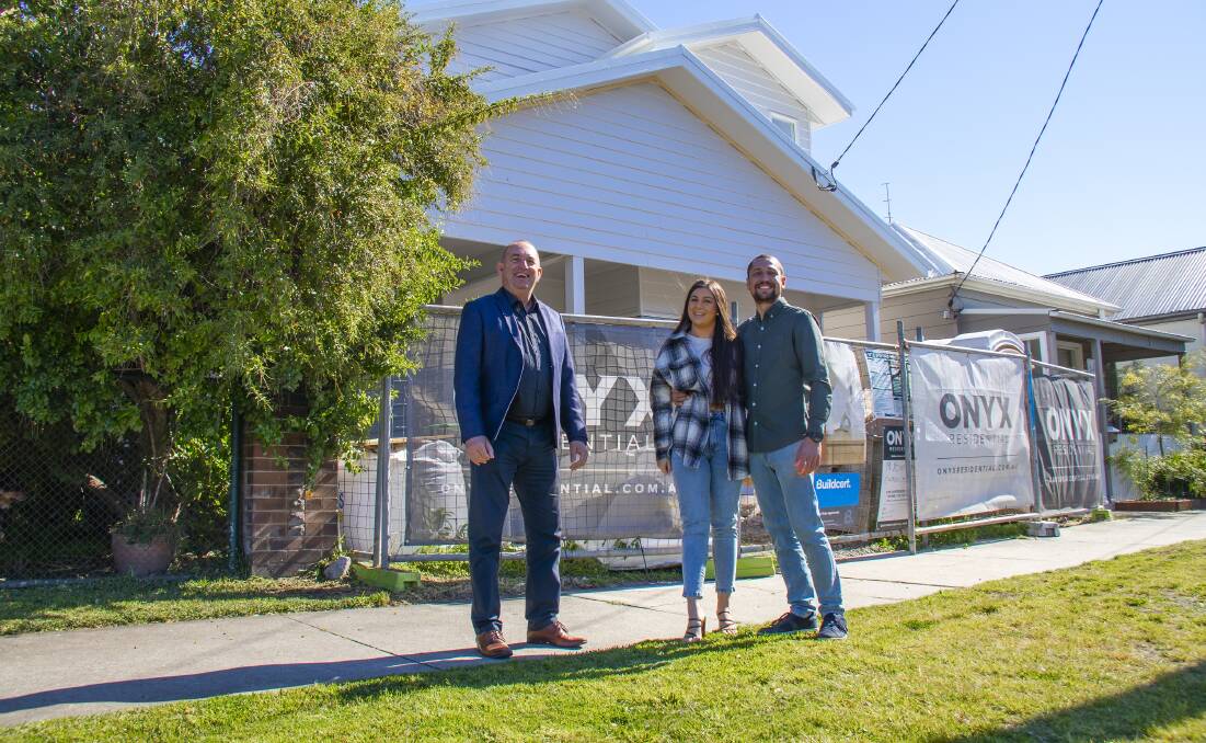 Decided to stay: Brett Bailey with his daughter Laura Hidalgo and her husband Michael outside their new home in Carrington.