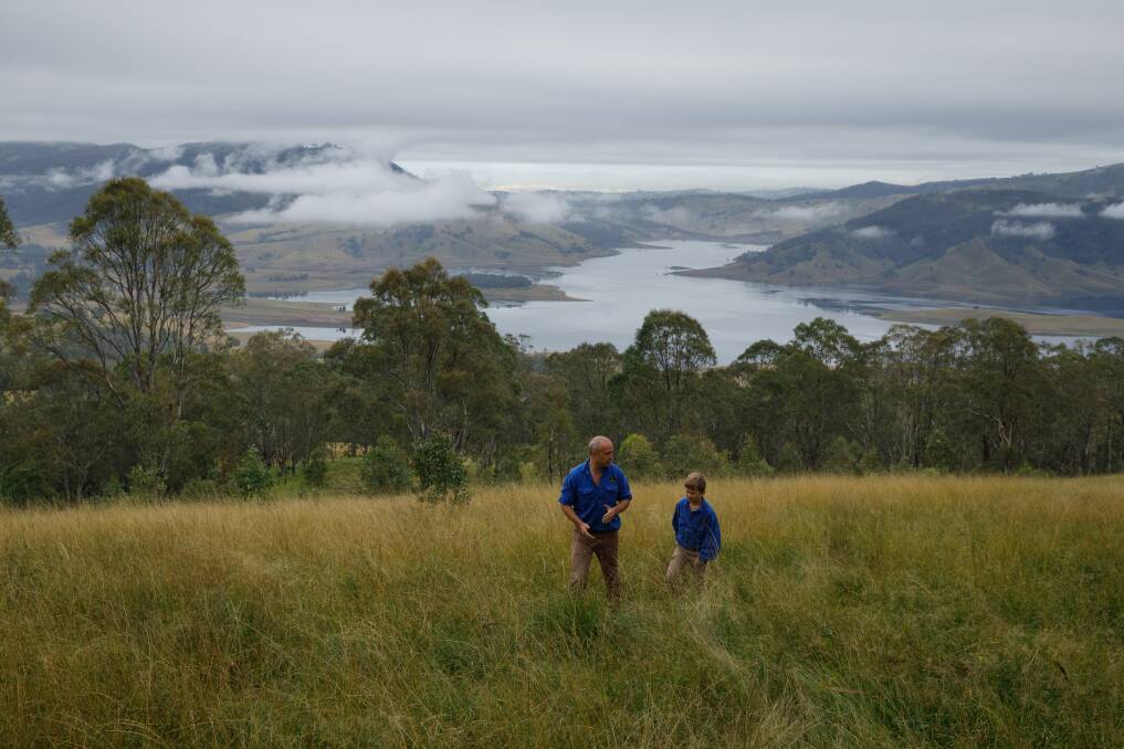 Idyllic: Steve Binnie and son Campbell on the family property, with Lake St Clair in the background. Picture: Max Mason-Hubers