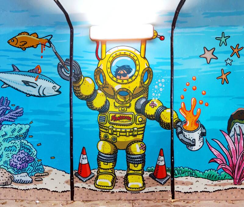 There's an artist in there: Trevor Dickinson's favourite image in his Merewether tunnel "Amazing Aquarium" mural is of himself, in a dive suit, on location. 