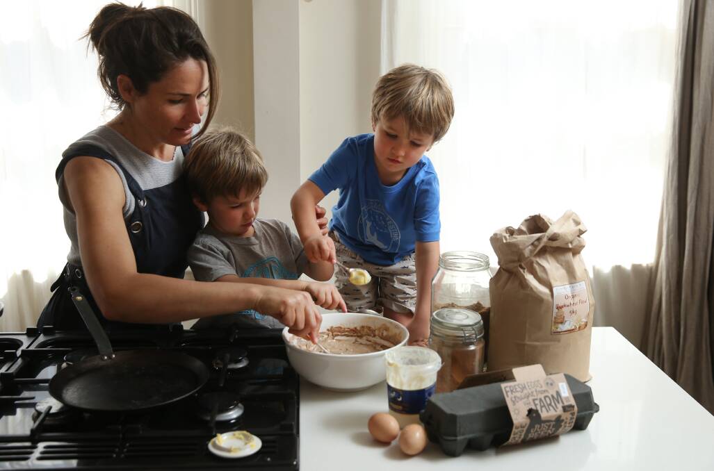 All in: Bec Bowie with her twin sons, Alby and Van, making pancakes at home. Picture: Marina Neil