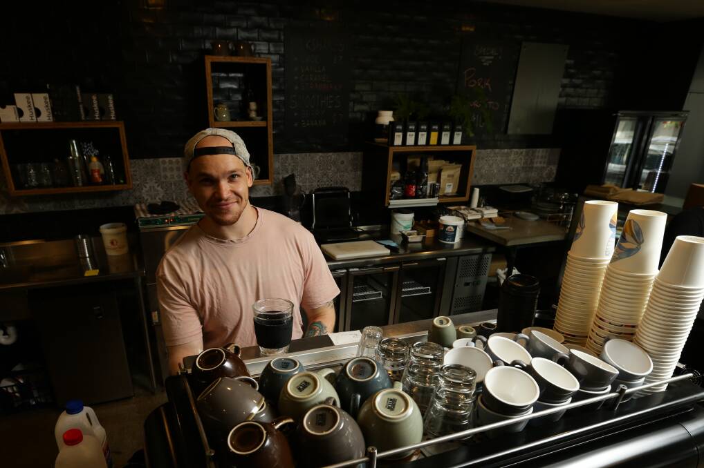 Top of his game: Alasdair Ewin, barista at Estratto, on the West End of Hunter Street. Picture: Jonathan Carroll
