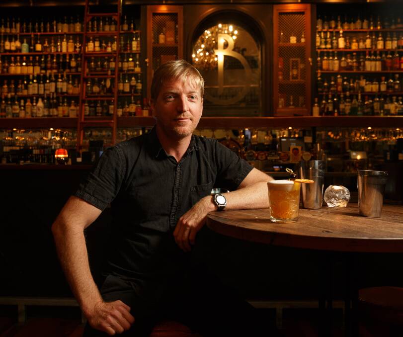 MIXING IT UP: Phil Elsley with a whisky sour cocktail at Babylon on King Street. Picture: Max Mason-Hubers