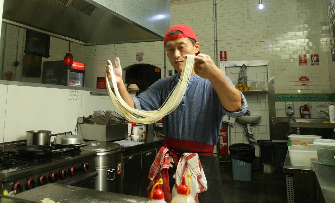 Perfection: Hua Fan, aka "Franky", doing what he does so well, making Lan Zhou noodles. Pictures: Jonathan Carroll
