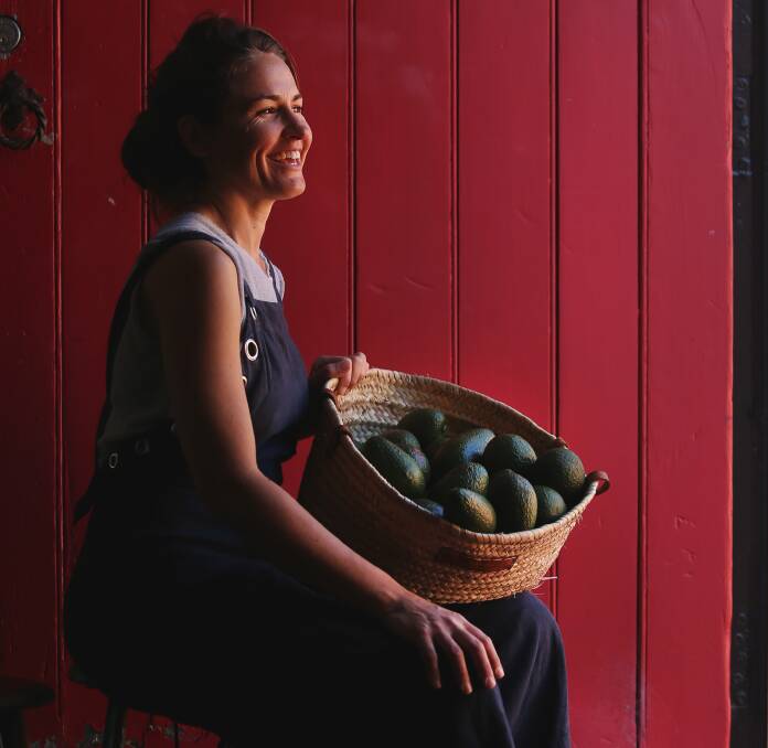 A fan of good food: Bec Bowie, owner of Estabar, with some Sandy Hill avocados, at her home in Newcastle East. As she says: "When you say no to gassed or cold storage fruit and veg, you just get what nature gives you. We think that's ok. This means sometimes we don't have ripe avocados and it means we always treat them each one of them as precious."  Picture: Marina Neil