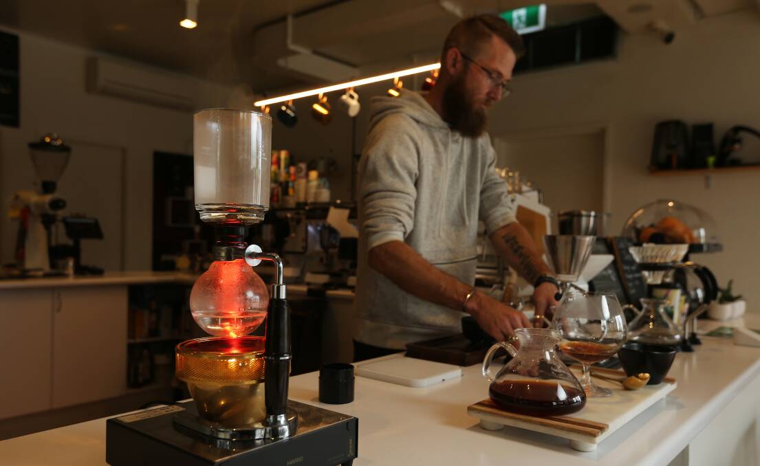Creative art: Owner Ben Stephens brewing concoctions in his Wickham coffee cafe. Picture: Simone De Peak