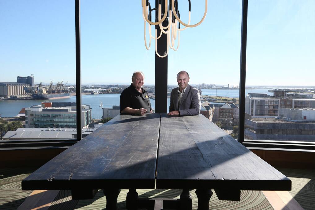 Newcastle Made: Mark Aylward with Crystalbrook Kingsley general manager Carl Taranto with one of Aylward's custom tables.Picture: Simone De Peak