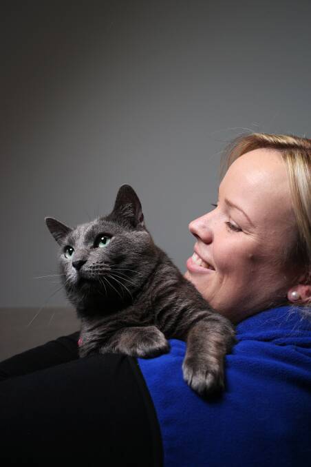 A cat's tale: Hunter RSPCA clinic manager Sally Armstead with Hamish, who spent more than three months at the shelter and in foster care after being picked up by the side of the road a stray. He had cat flu, and proved to a handful in care, biting and scratching staff, before they discovered he had an injury to one of his limbs. Once attended to, he eventually recovered, and was adopted this weeek. Picture: Simone De Peak