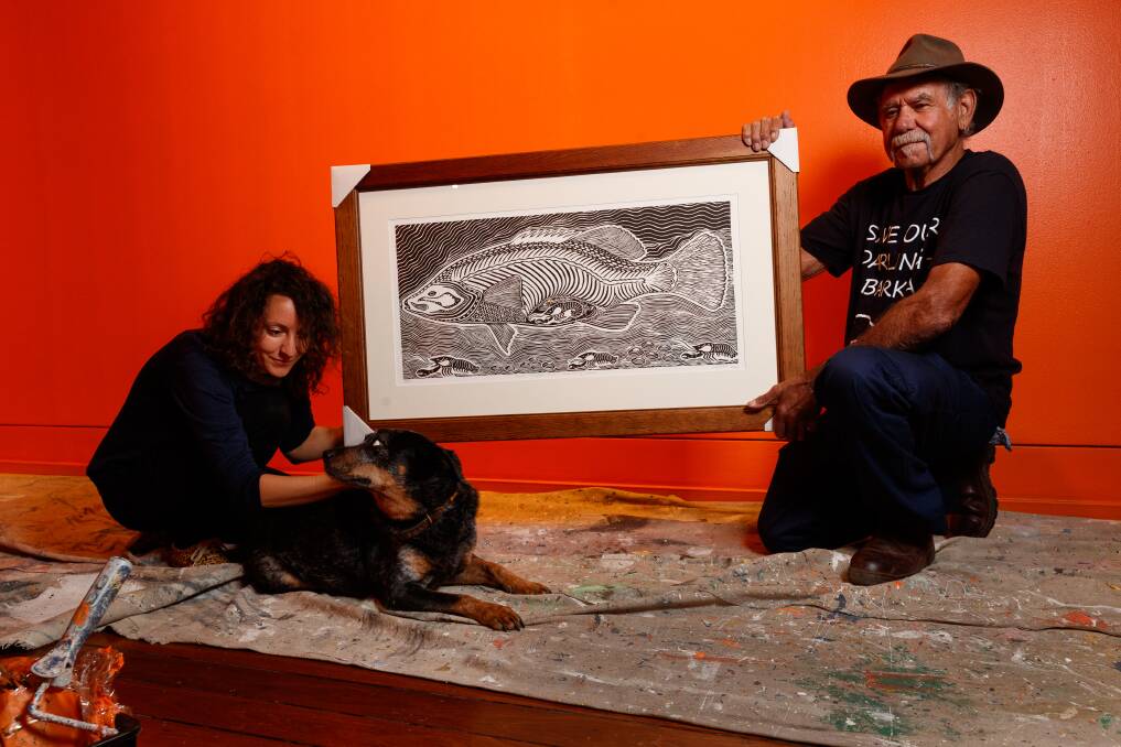 A story to tell: Artists Justine Muller and Uncle Badger Bates with Tenzi the dog installing their exhibition at Maitland Regional Art Gallery. Picture: Max Mason-Hubers