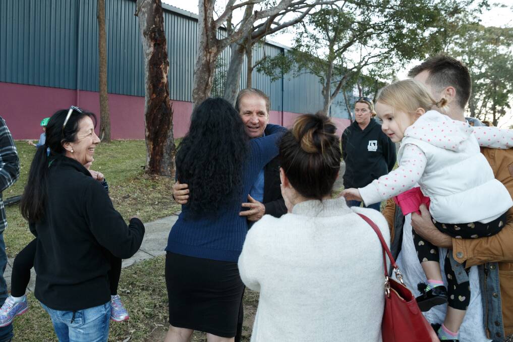 FALSE DAWN: Michael Constantine (centre) is hugged by Whitebridge residents earlier this month. Picture: Max Mason-Hubers