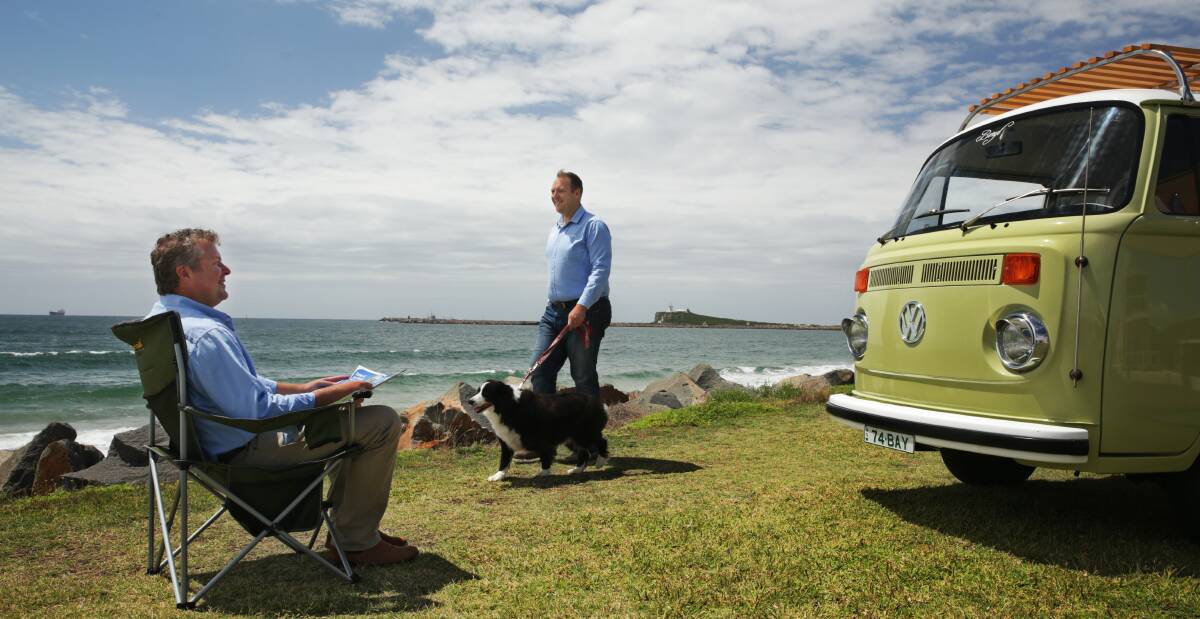 OUT AND ABOUT: Camplify co-founders Josh Fischer and Justin Hales with dog Storm in a retro camper. Picture: Simone De Peak