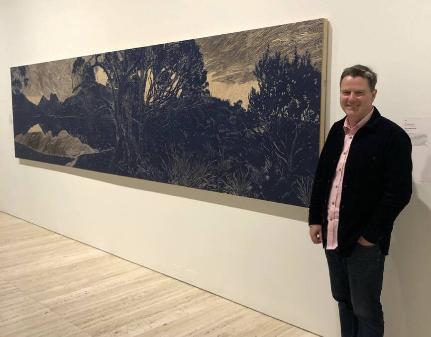 HIGH PRAISE: Graham Wilson with his woodcut of Cradle Mountain - Tasmania which is hanging in the Art Gallery of NSW.