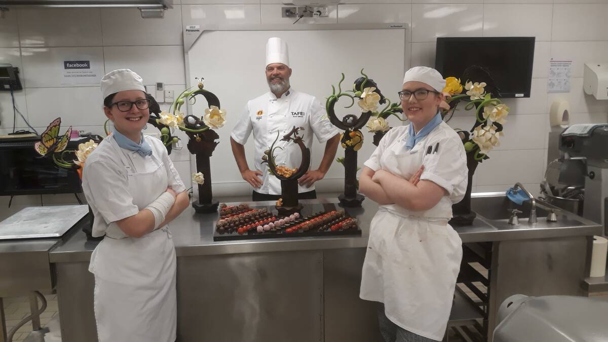 TAFE NSW Hamilton students Chelsea Richter and Jo Gray with teacher and pastry chef Dean Gibson.