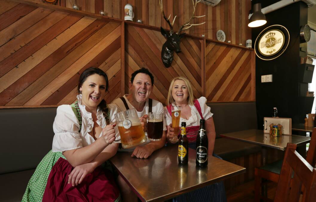 CHEERS: Victoria, Mark and Cathy Fren get into the Oktoberfest spirit at Oma's Kitchen. Picture: Simone De Peak