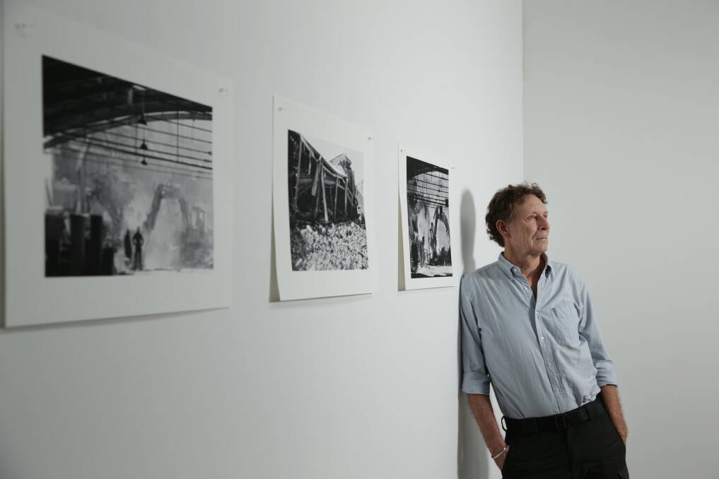 Steve Tickner with some of the images he took almost 30 years ago during the Newcastle earthquake. Exhibiting now at Newcastle ArtSpace. Picture: Simone De Peak 
