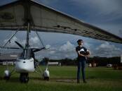DEDICATED: Amellia Formby and her microlight at Lake Macquarie Airport, Marks Point. Picture: Marina Neil