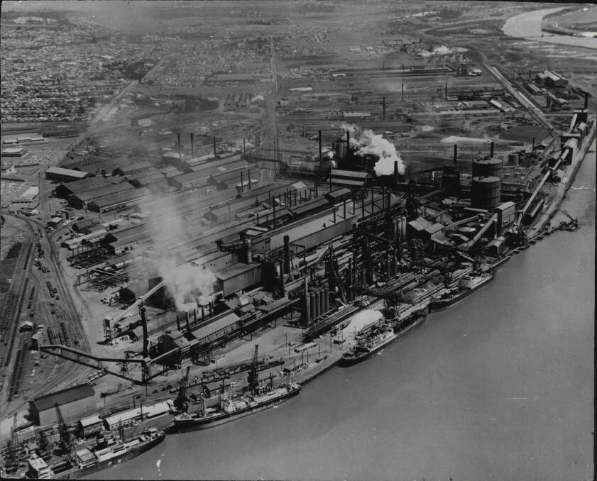 The way we were: An aerial scene in the 1940s of the BHP waterfront with the smoky Newcastle Steelworks behind.