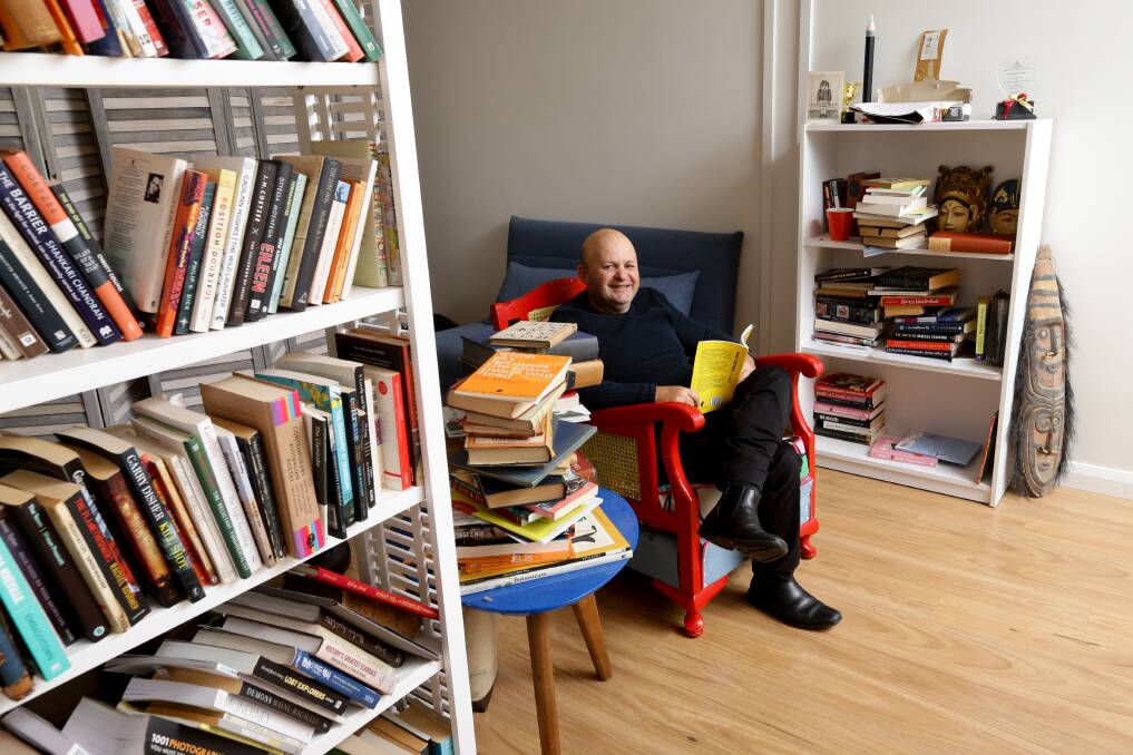 WAY WITH WORDS: Poet, writer, book editor and harmonica player Ed Wright at home in his Wickham office. Picture: Jonathan Carroll