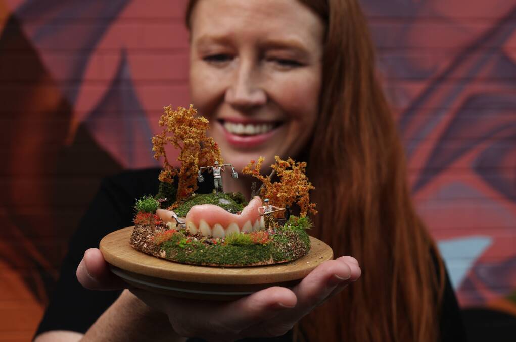 Jacinta Fintan holds a work by miniature artist Tinky which will be installed near Chaddies on Regent. Picture by Simone De Peak 