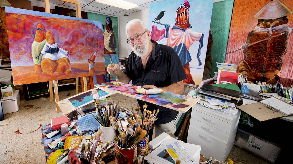 DRESS UP: Ian Hance with a selection of his striking paintings. Picture: supplied.