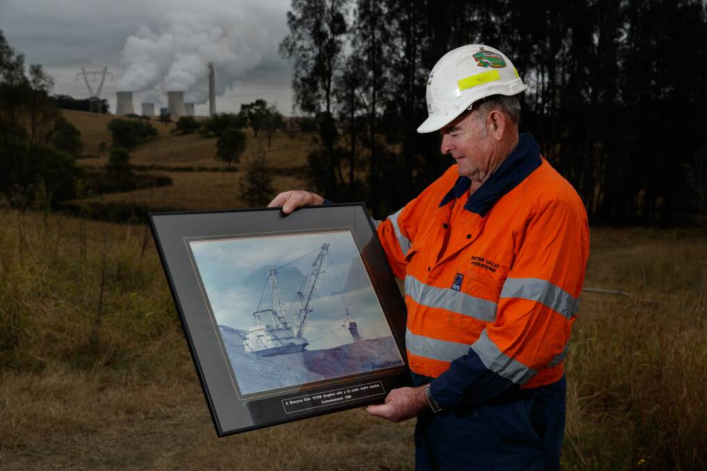 King Coal: Peter Constable is retiring after 53 years as a coal miner. The framed photo shows a dragline he operated, with Bayswater Power Station in the distance. Picture: Max Mason-Hubers 