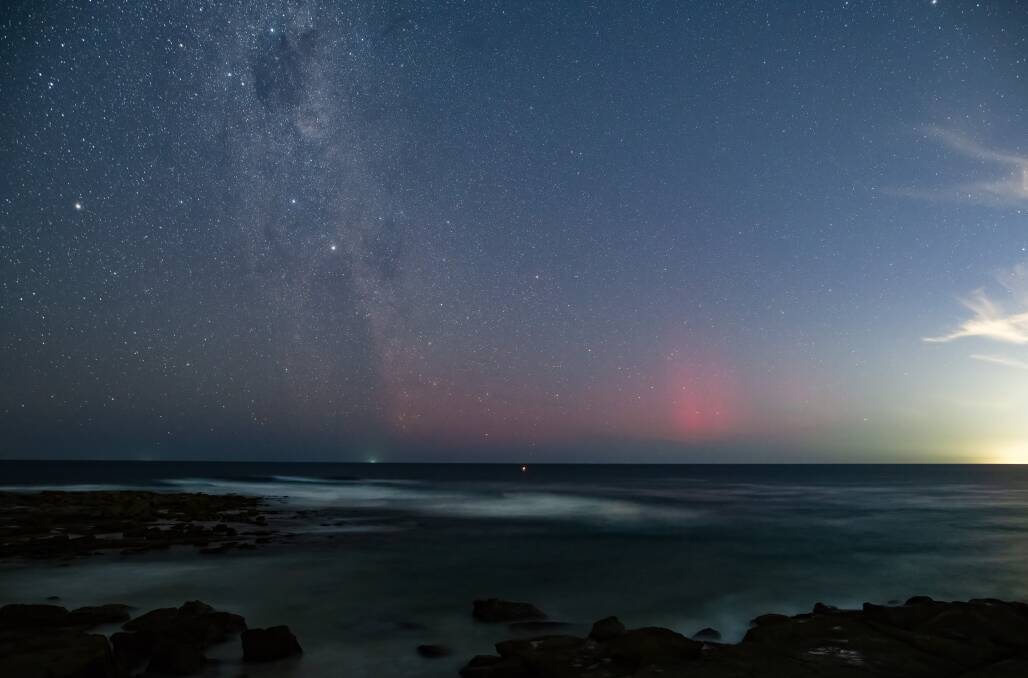 The Aurora Australis seen through a camera lens at Soldiers Beach on the Central Coast. Picture by Ian Williams 