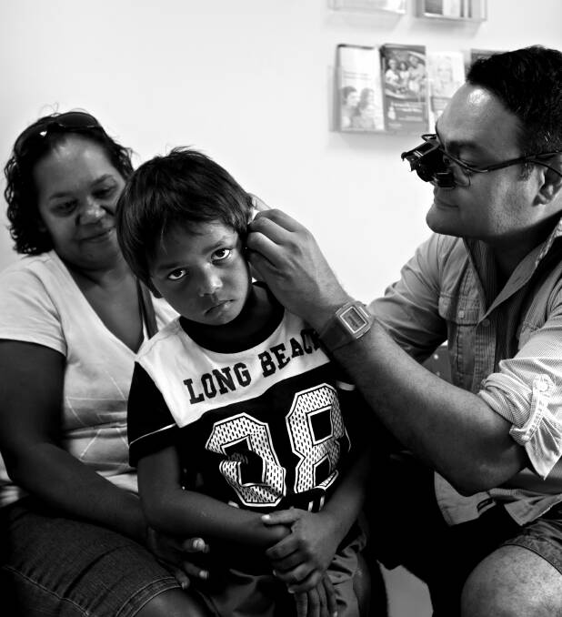 On Duty: Kelvin Kong treats a patient in Broome in 2015. Picture: Simone De Peak 
