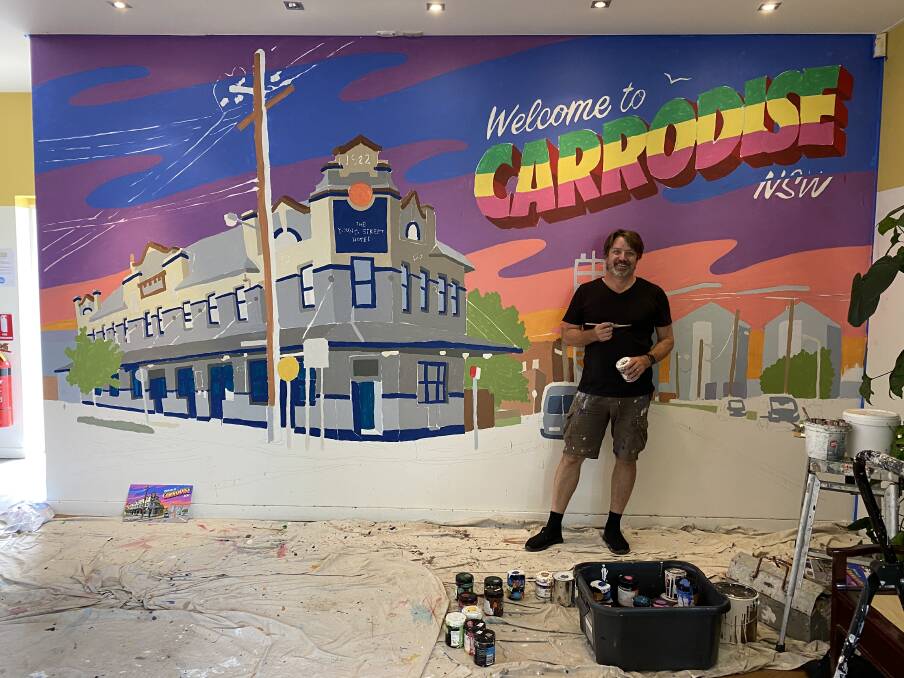 In Progress: Newcastle artist Trevor Dickinson working on a new mural at The Young Street Hotel at Carrington. 
