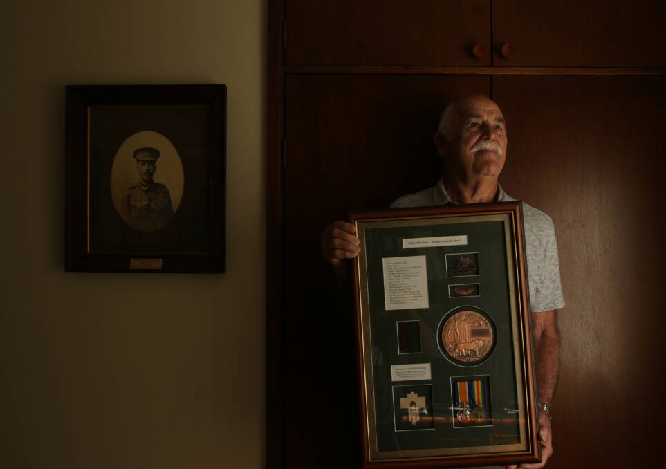 Honoured: Ron Crebert with a framed roll of honour for Walter Crebert and a framed photo of Albert Crebert on the wall. Picture: Simone De Peak    