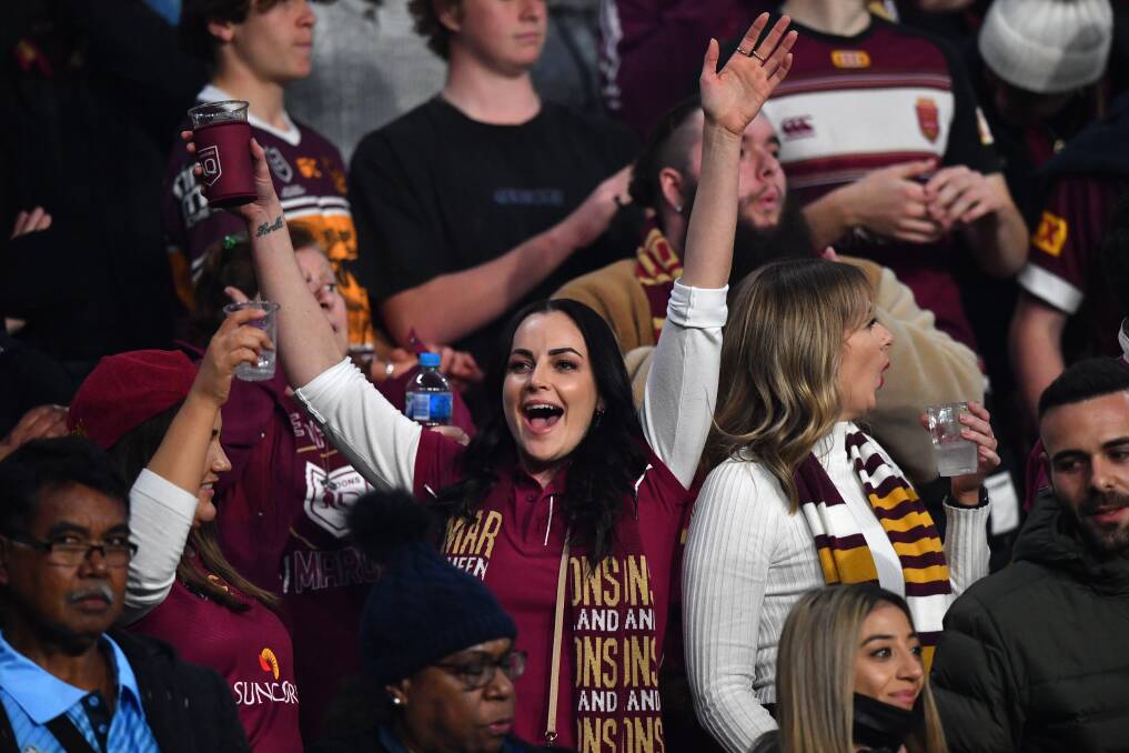 Hot Ticket: Fans during game two of the State of Origin in Brisbane. Ticket sales for game three in Newcastle open on Monday. Picture: AAP/Darren England 