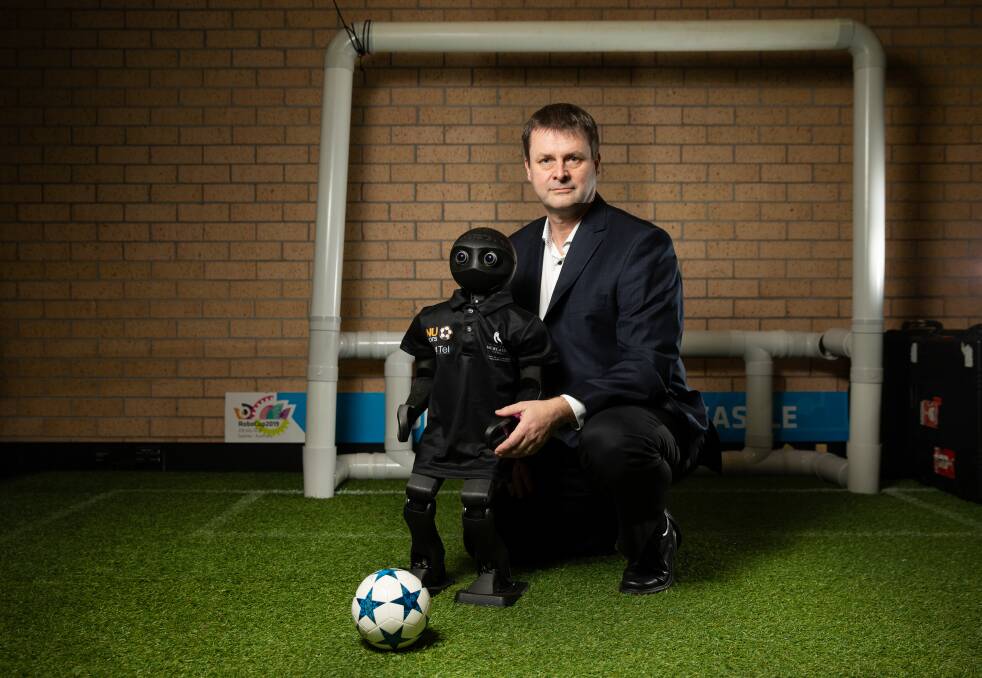 Robotics: Dr Stephan Chalup with a robot soccer player, called a Nubot. His latest research involves deep learning, which relates to artificial intelligence and machine learning. Picture: Marina Neil 