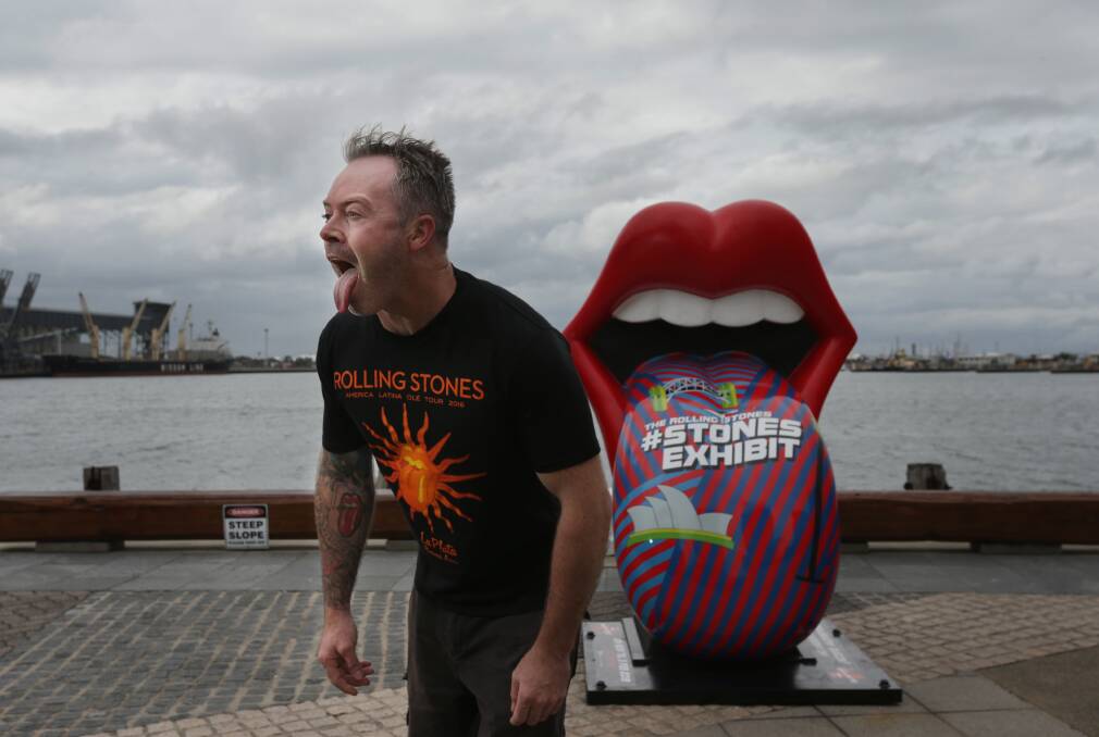 Rock'n'Roll: Dane Watt with a Rolling Stones statue at Honeysuckle, installed to promote an exhibition in Sydney. Picture: Simone De Peak
   