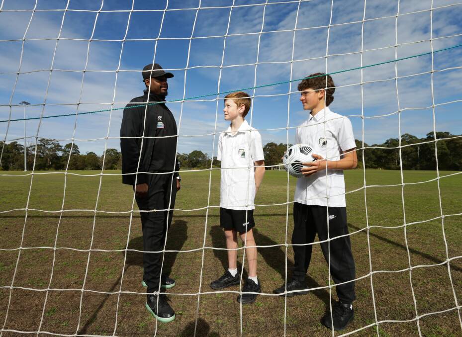 Sidelined: Newcastle Jets youth technical director Kew Jaliens with under 13 and 14 captains Lawson Weeks and Alex Nunes. Picture: Jonathan Carroll 