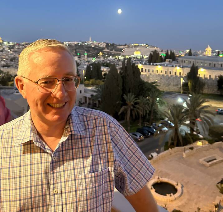 Father Greg Barker in Israel, overlooking the old city of Jerusalem, before the invasion. Picture supplied 