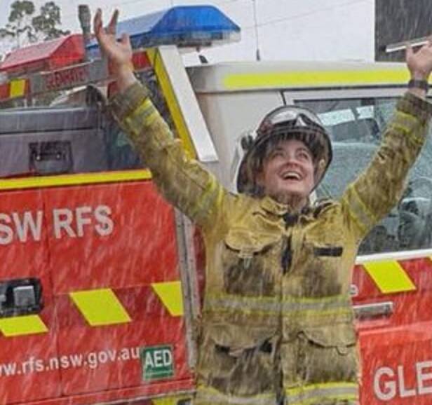 Happy Days: An RFS volunteer rejoices in the rain. Picture: NSW RFS 