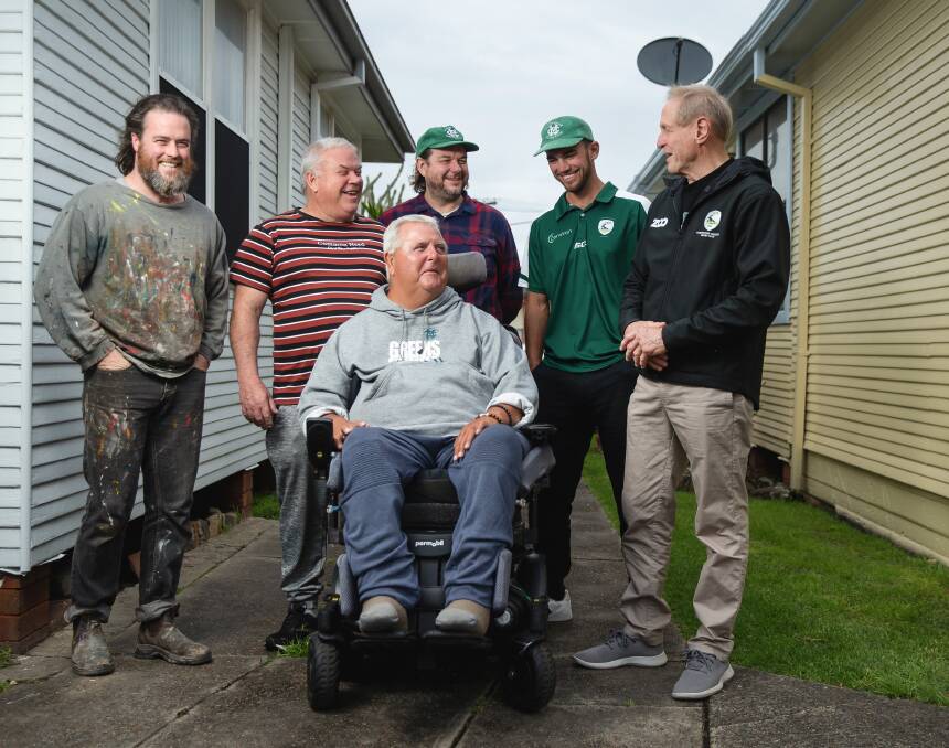 Noel Burt with (from back left) artist James Drinkwater, Leon Davis and Merewether Carlton Rugby Club member Justin Lees, first grade captain Sam Rouse and president John Davis. Picture by Marina Neil 