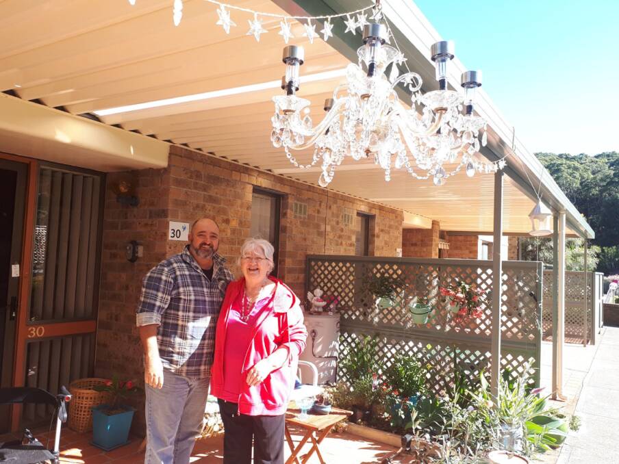 Light Dawns: Matt Hallcroft and Eunice C. English with the chandelier. "I can now swing from the chandelier - literally," Eunice said. 