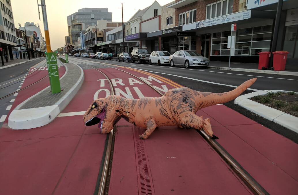 An inflatable tyrannosaurus rex fell over the tram tracks in Newcastle.  