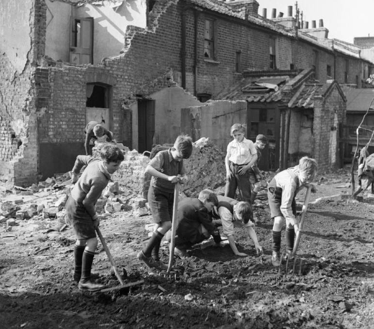 Beans: Boys clear prepare the ground to plant beans on a bomb site in London in 1942. Picture: Imperial War Museum 