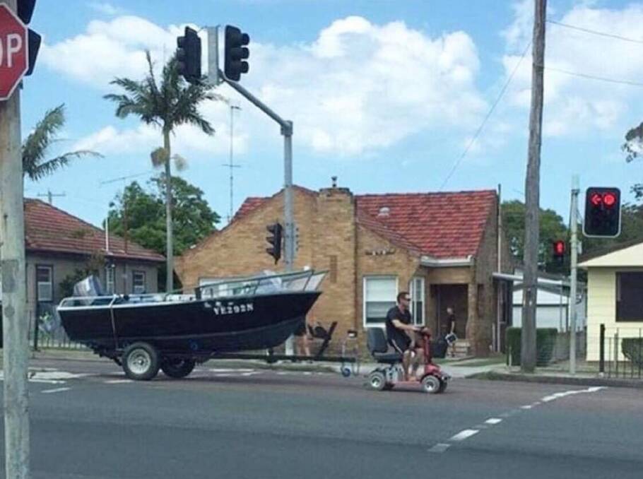 Mobility man towing a boat at Belmont. The boat is up for sale. 