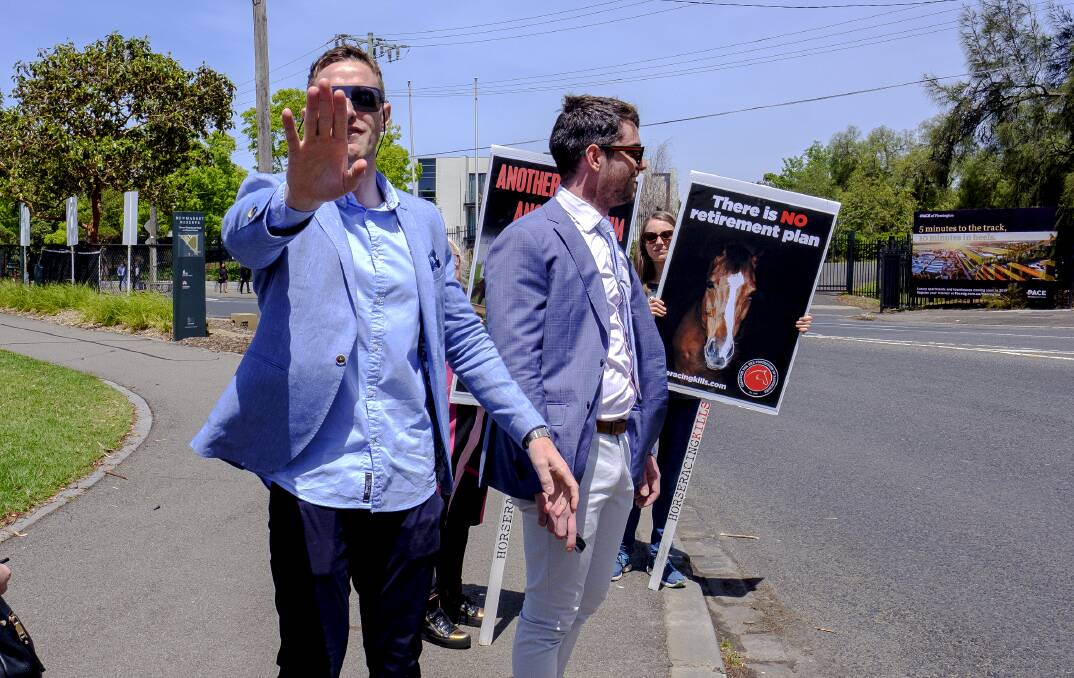 Great Divide: Punters crossing path with anti-horse racing protesters on Melbourne Cup day. Picture: Luis Ascui 