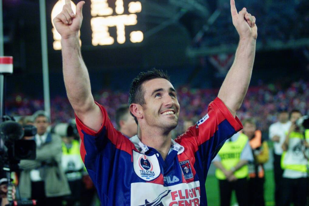 Winner: Andrew Johns celebrates the Knights grand final victory over Parramatta Eels in 2001. Picture: Anita Jones 