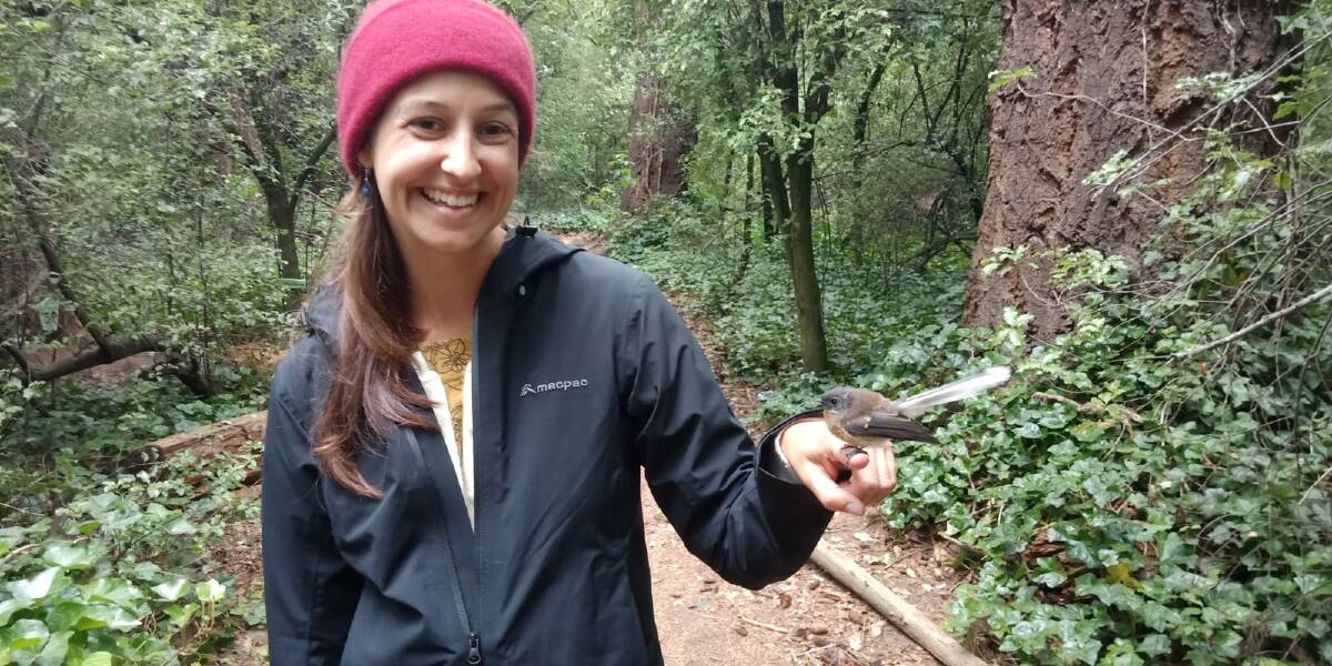  Dr Kaya Klop-Toker with a little bird in the bush. 