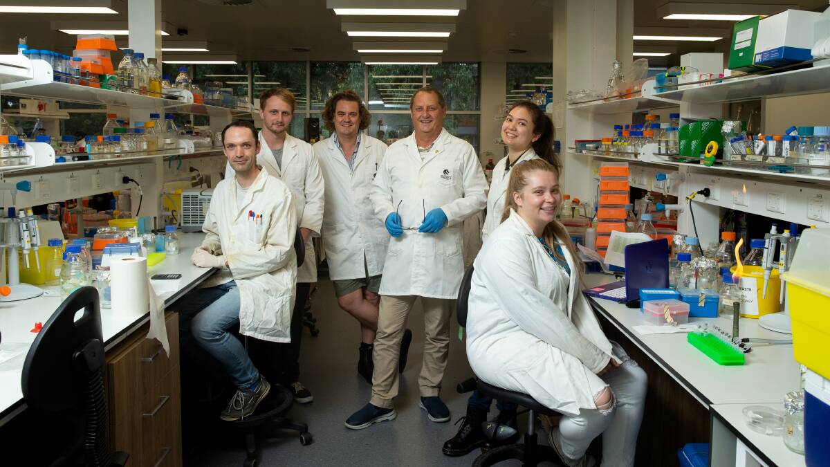 White Coats: Professor Brett Neilan and his team at the Centre of Excellence in Synthetic Biology at the University of Newcastle. We do love this photo, but we reckon their coats could use a splash of colour. Picture: Marina Neil 