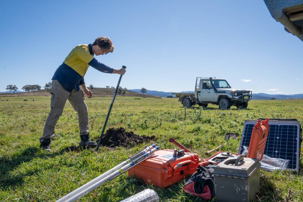 Breaking Ground: A worker prepares to bury a sensor to learn more about what lies beneath the surface. 