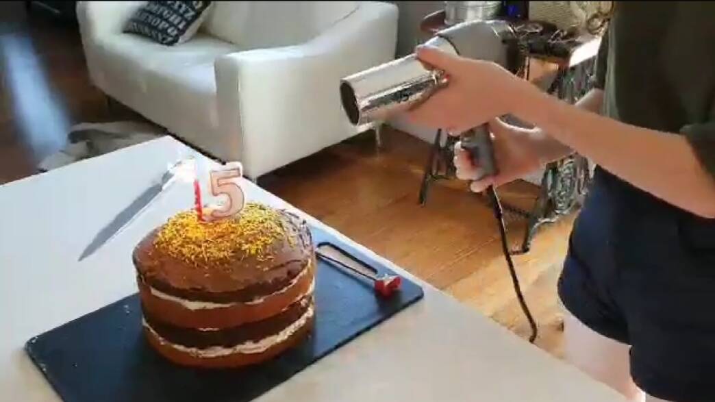 Innovation: Reyna, 15, blows out candles with a hairdryer. 