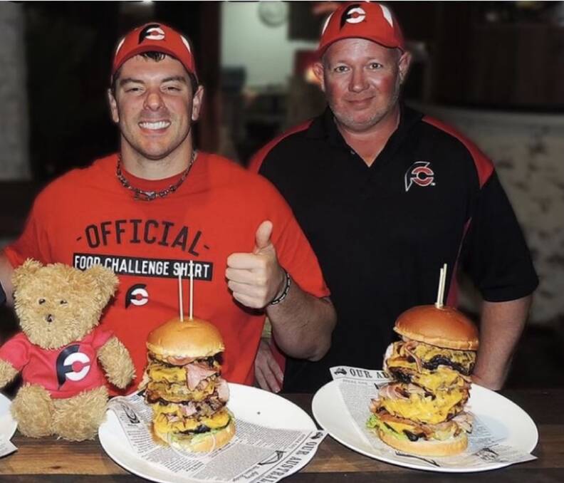 Randy Santel and Jamie Miller taking on a burger challenge in Hamilton in 2017. 
