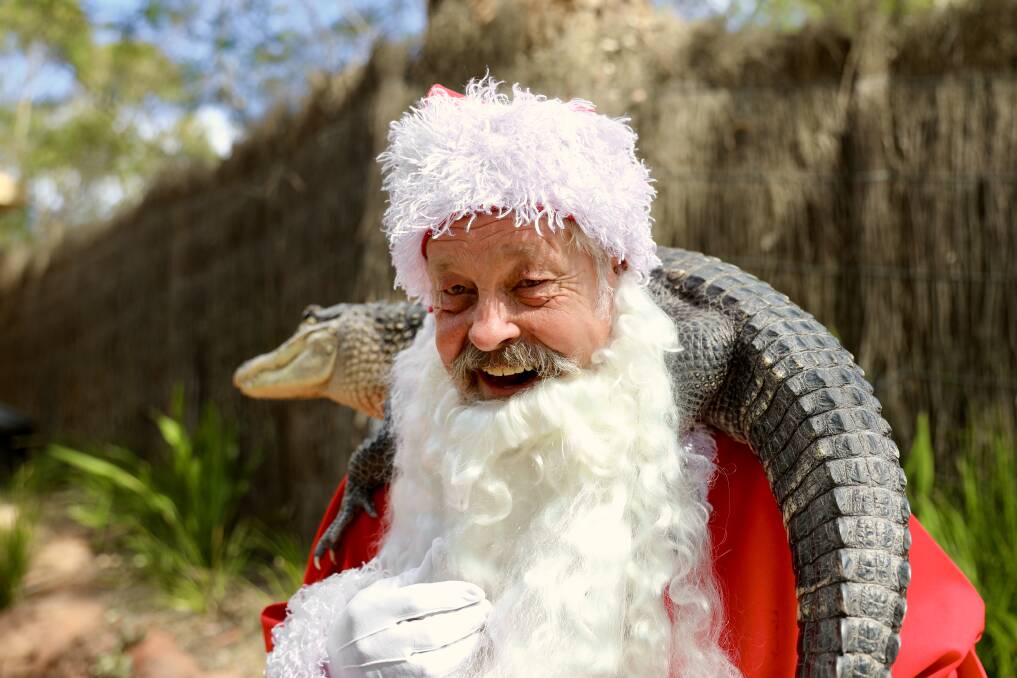 Crikey: Santa with Rosie the American alligator. Animals like Christmas too. So we hear, anyhow. Pictures: Australian Reptile Park 