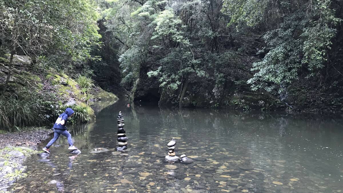 A Stone's Throw Away: AJ Bath at a river in the Barrington Tops with artistic stacks of stone that channel ancient times. 